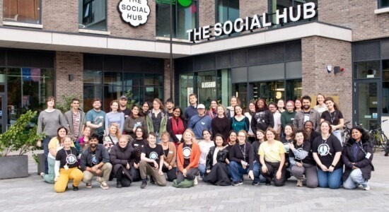 group of people in front of the The social hub building